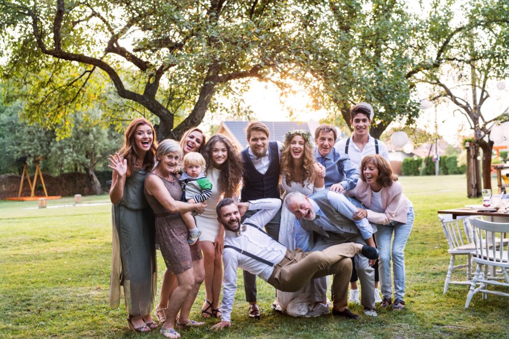 Bride, groom, and a small group of guests gathered for a photo at an outdoor Tennessee wedding reception